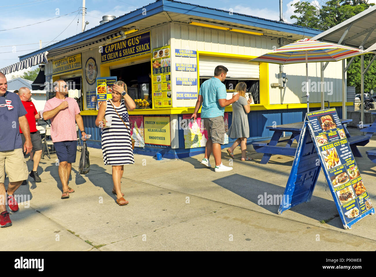 The July 2018 heatwave over northeast Ohio shows as visitors to Geneva-on-the-Lake sweat during a walk along the resort town strip. Stock Photo