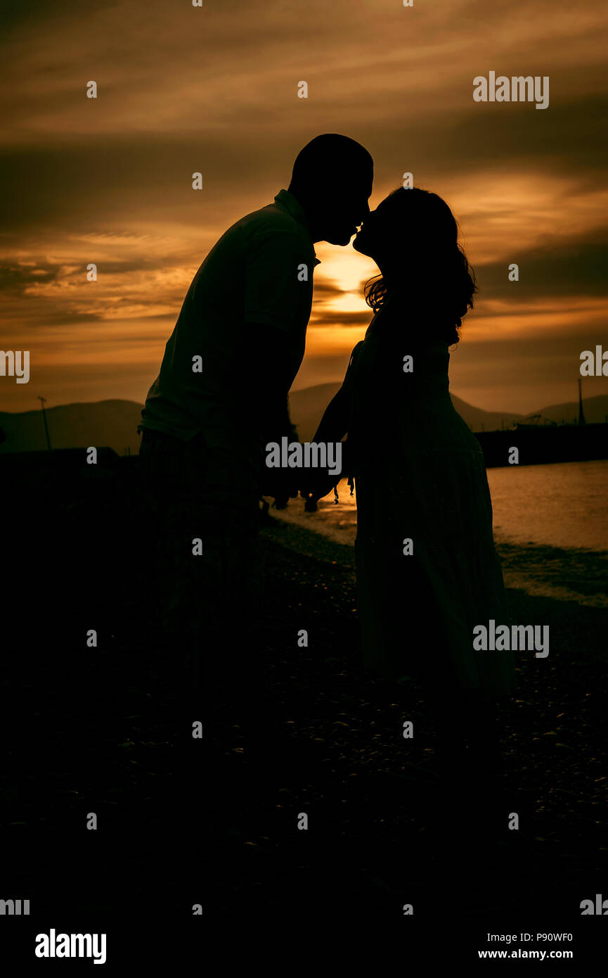 Silhouette of a couple on the beach Stock Photo - Alamy