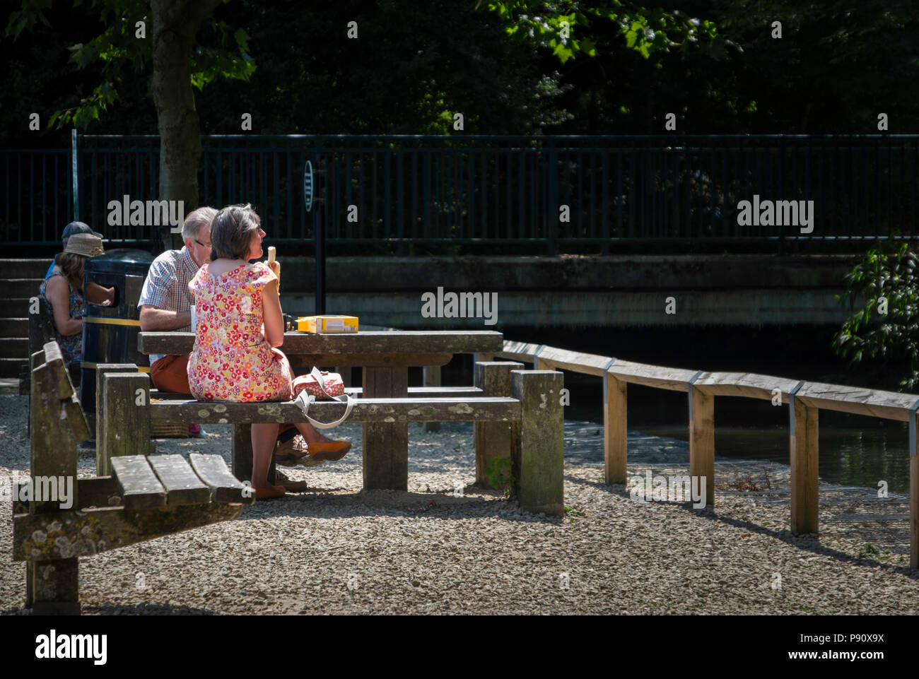 Having a picnic on the bank of the river Windrush in Burford. Stock Photo