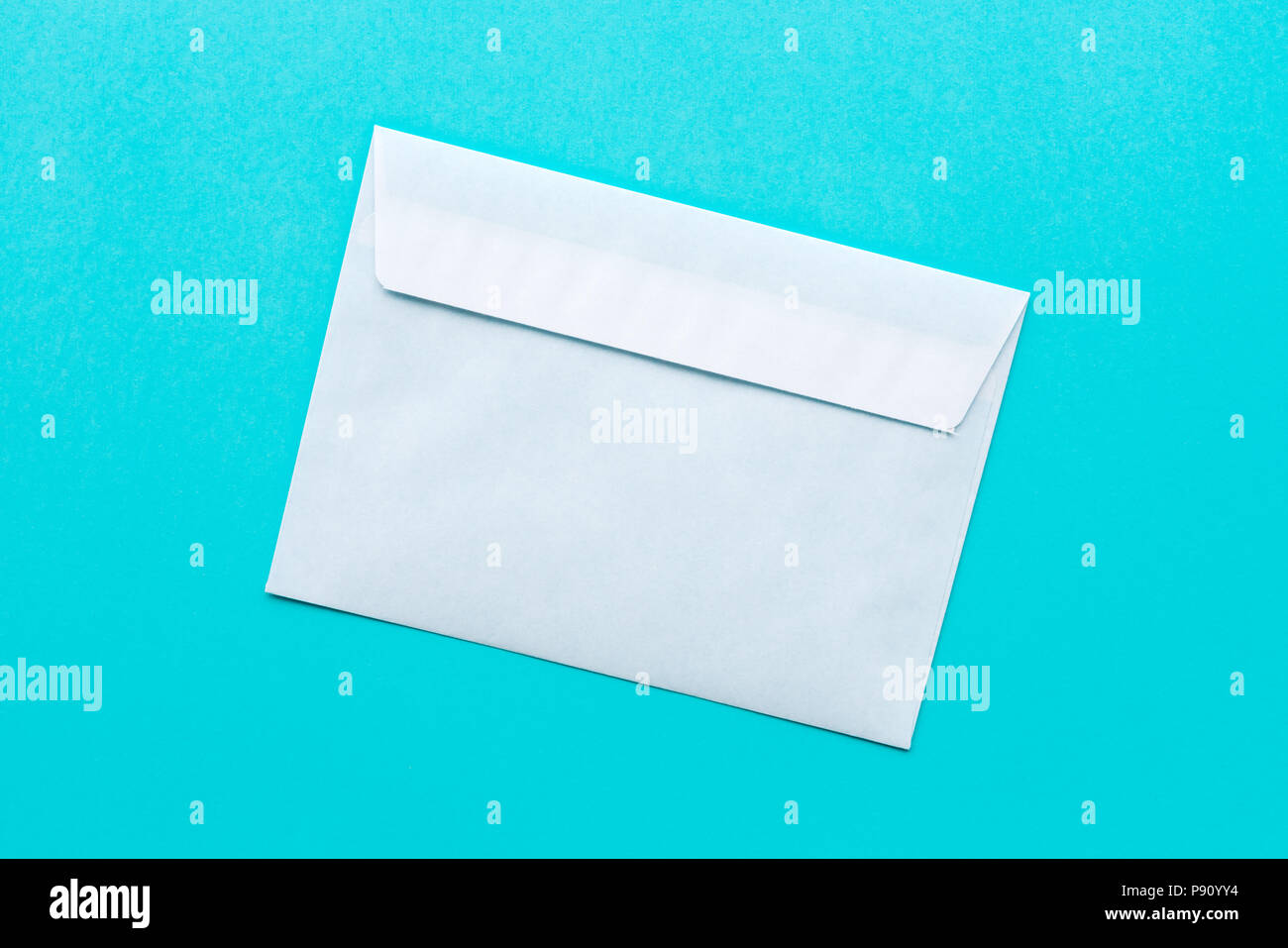 White mail envelope mock up on blue background Stock Photo Alamy