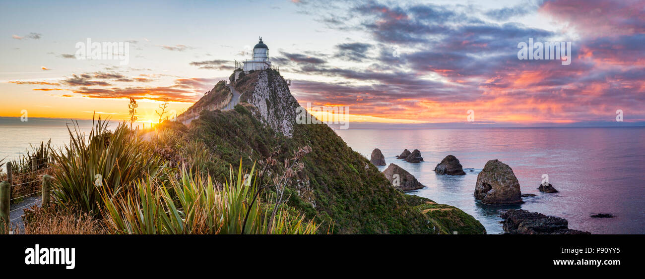 Panoramic view of sunrise at Nugget Point, Catlins, Otago, in New Zealand's South Island. Stock Photo