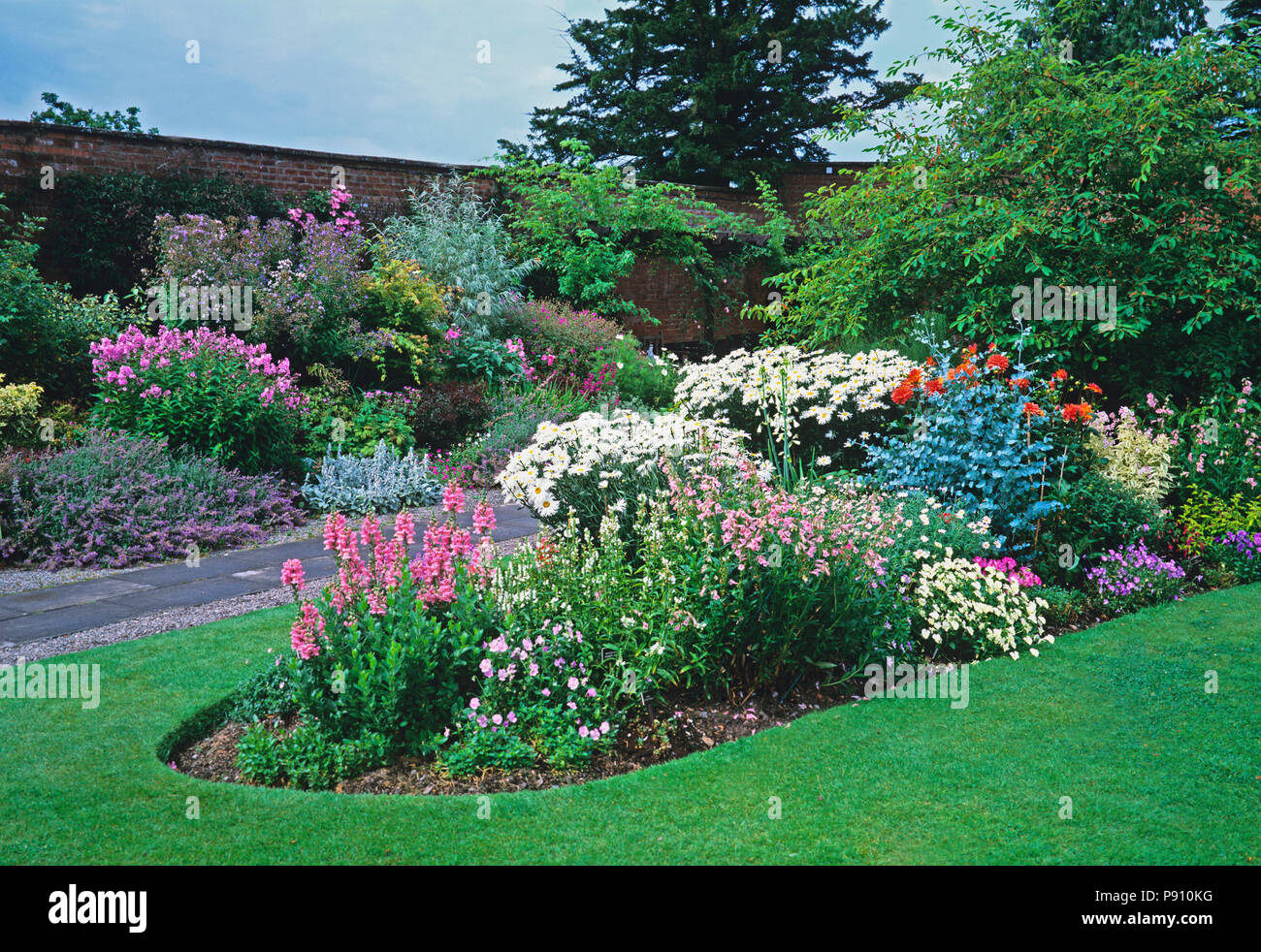 Pink and white flower bed at country garden Stock Photo