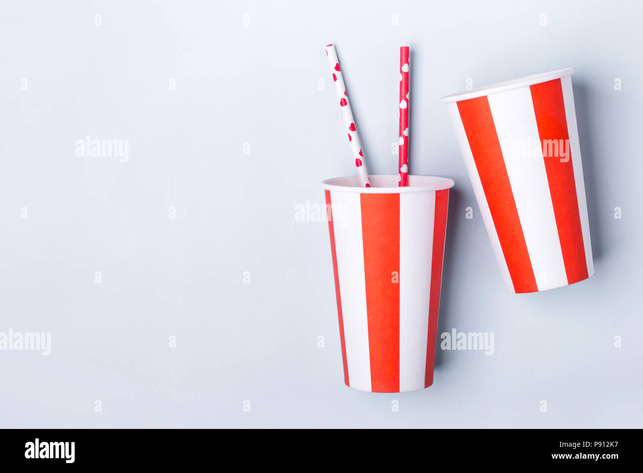 Two Empty striped paper cup on a blue background. Stock Photo