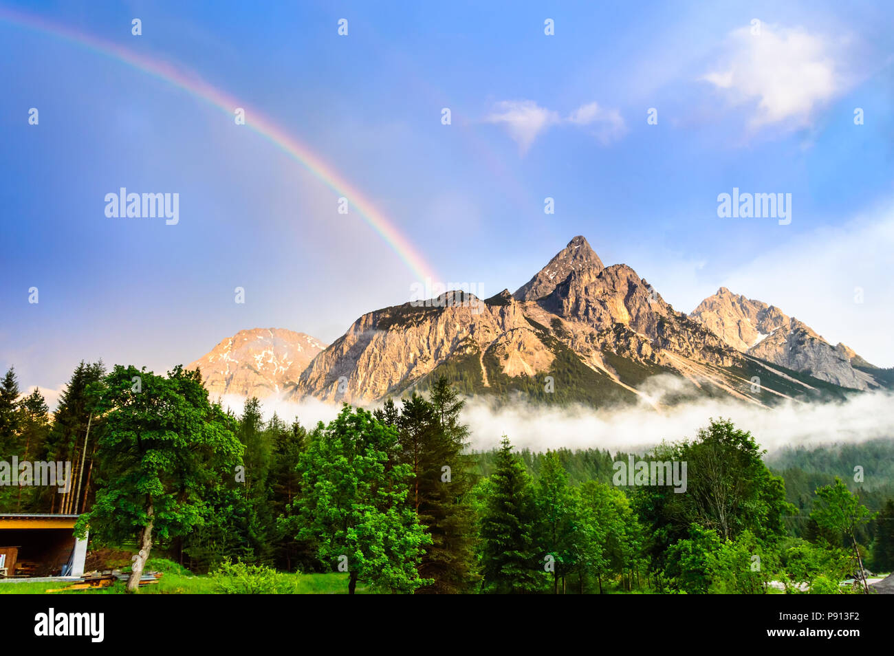 Rainbow over the Ehrwalder Sonnenspitze mountain in the austrian Alps - Ehrwald, Tyrol, Austria. Stock Photo