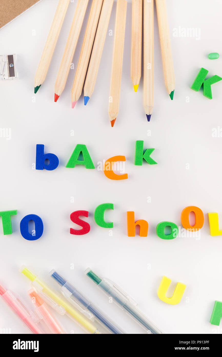Creative flat lay back to school concept with alarm clock, color school ...