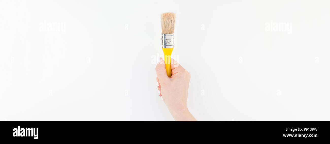 Long wide banner of woman hand holding new paint brush with copy space ...