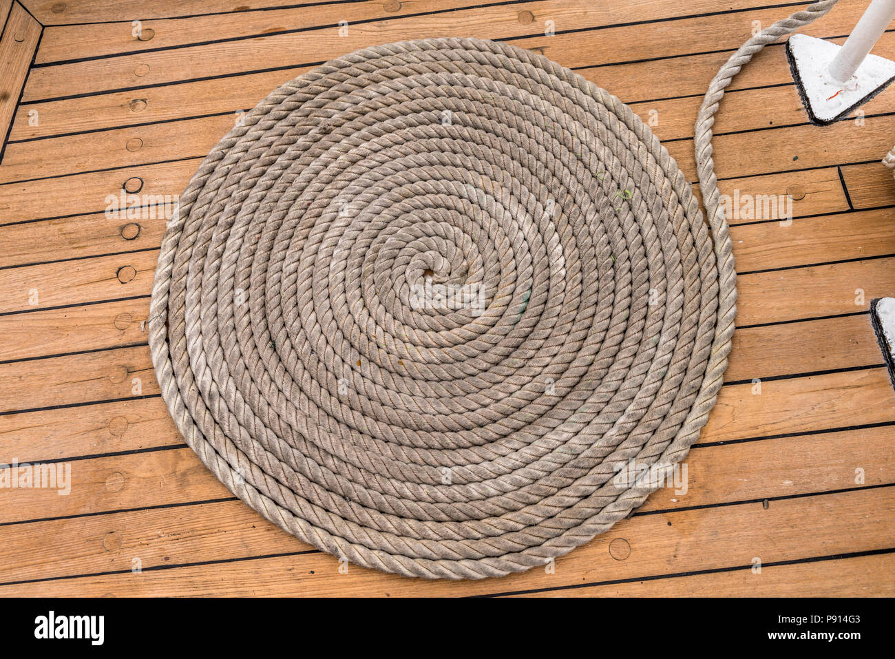 Sail boat rope -- rope-on-dock - dock line coil Stock Photo