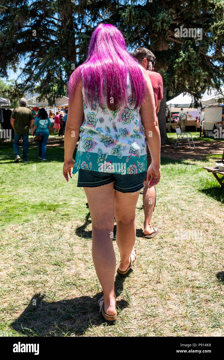Woman with long purple hair walking in park; Salida; Colorado; USA Stock Photo