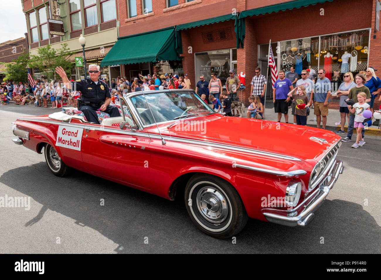 Retiring Salida Police Chief Terry Clark; parade Grand Marshall; antique car; annual Fourth of July Parade in the small Colorado mountain town of Sali Stock Photo