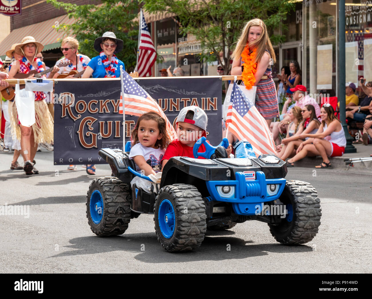 Children drive toy 4-wheeler in annual Fourth of July Parade in the small Colorado mountain town of Salida. Stock Photo