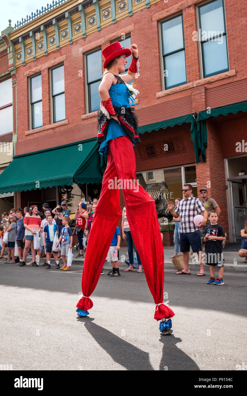 Costumed Salida Circus character marches on stilts in annual Fourth of July Parade in the small mountain town of Salida; Colorado; USA Stock Photo
