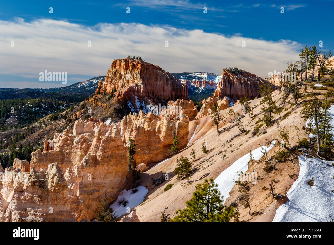Winter view of Swamp Canyon & Butte in Bryce Canyon National Park, Utah. Clouds break up the blue sky. Stock Photo