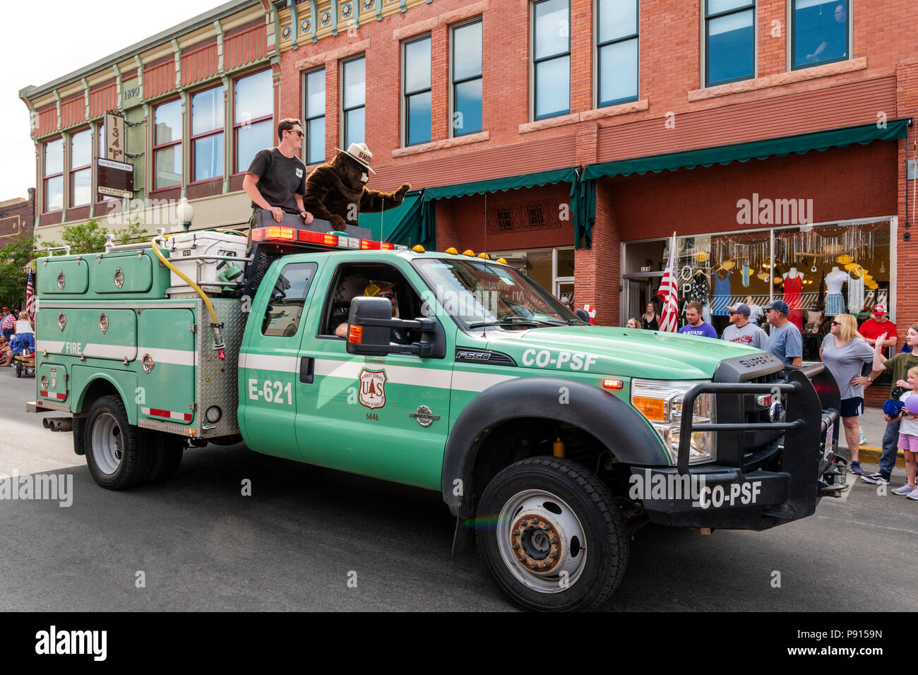 Smokey the Bear riding in US Forest Service truck; Fourth of July parade in the small mountain town of Salida, Colorado, USA Stock Photo