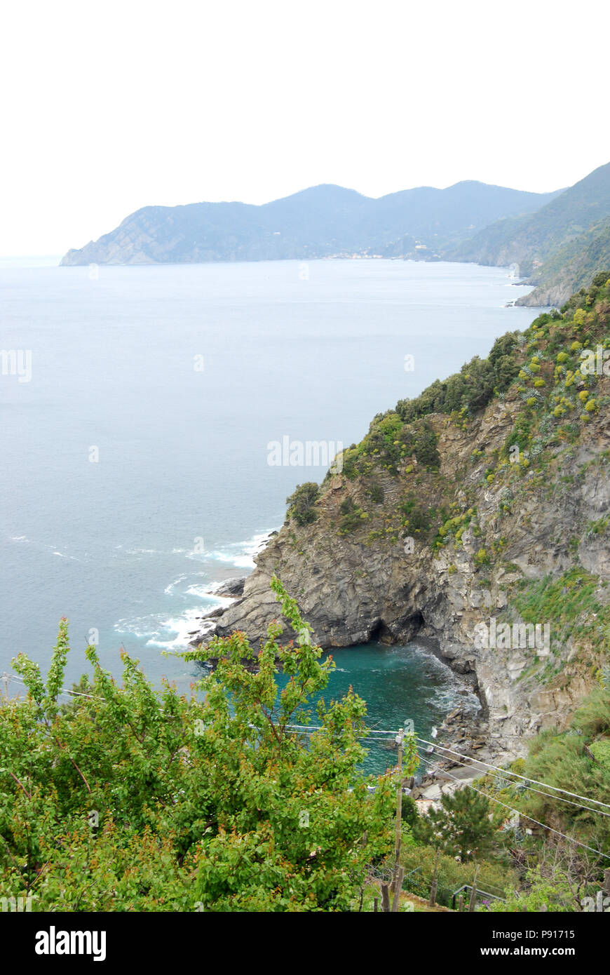 Coastal landscape of cliffs along path between villages of Cinque Terre ...