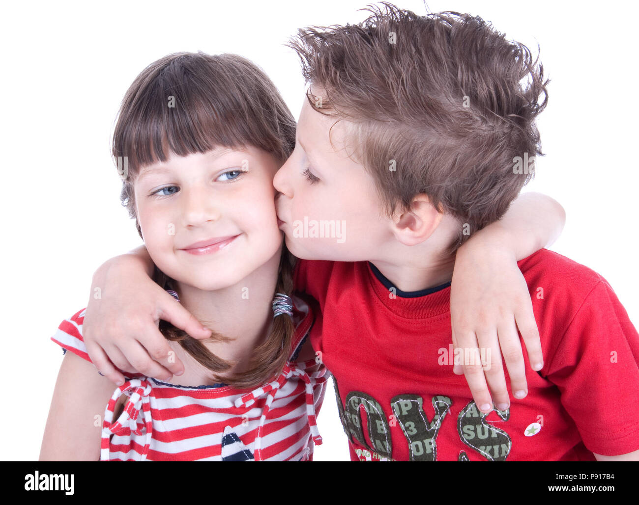 Cute boy kissing a nice girl, studio shot Stock Photo - Alamy