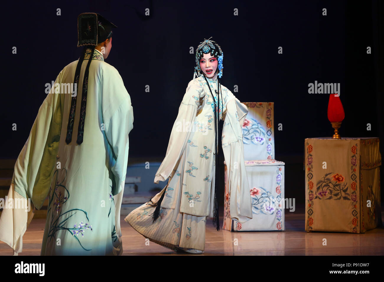 Tianjin, China. 13th July, 2018. College students perform Kunqu Opera 'the Peony Pavilion' at Nankai University in Tianjin, north China, July 13, 2018. 'Peony Pavilion', created by ancient Chinese playwright Tang Xianzu (1550-1616), tells a love story between Du Liniang and Liu Mengmei, embodying young people's pursuit of love and freedom. Credit: Liu Dongyue/Xinhua/Alamy Live News Stock Photo