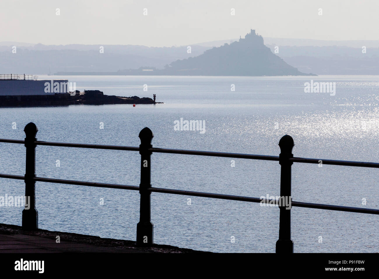 St Michael's Mount, Penzance, Cornwall, UK.  14th July 2018. Calm sea conditions and bright haze attract swimmers, sailors and sea life to the Cornish Coast.  Credit:  Mike Newman/Alamy Live News Stock Photo