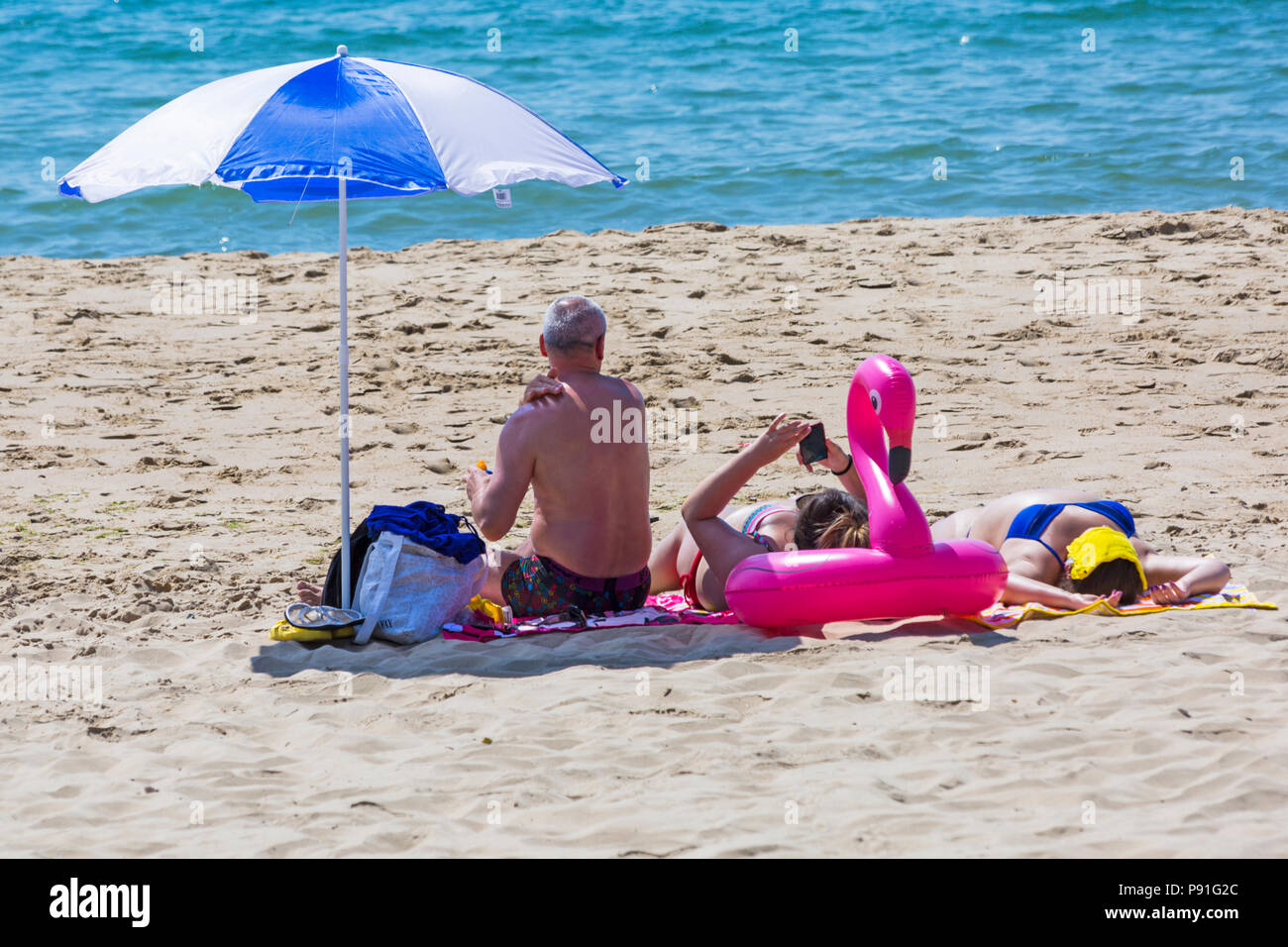 Bournemouth, Dorset, UK. 14th July 2018. UK weather: The heatwave continues with another hot sunny day, as sunseekers make the most of the glorious weather and head to the seaside at Bournemouth beaches. Sunbathers on the beach. Credit: Carolyn Jenkins/Alamy Live News Stock Photo