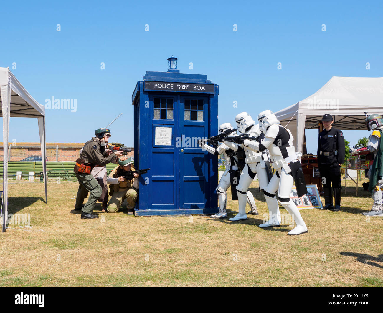 Sheerness, Kent, UK. 14th July, 2018. Sheppey Sci-Fi festival: a festival celebrating all things sci-fi was held today at Barton's Point on the Isle of Sheppey in Kent to celebrate Sheppey Miniature Engineering and Model Society's 40th anniversary. Pic: a replica Tardis from Doctor Who, with Stormtroopers. Credit: James Bell/Alamy Live News Stock Photo