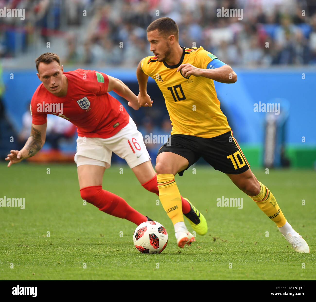 Saint Petersburg, Russia. 14th July, 2018. Phil Jones (L) of England vies with Eden Hazard of Belgium during the 2018 FIFA World Cup third place play-off match between England and Belgium in Saint Petersburg, Russia, July 14, 2018. Credit: Li Ga/Xinhua/Alamy Live News Credit: Xinhua/Alamy Live News Stock Photo