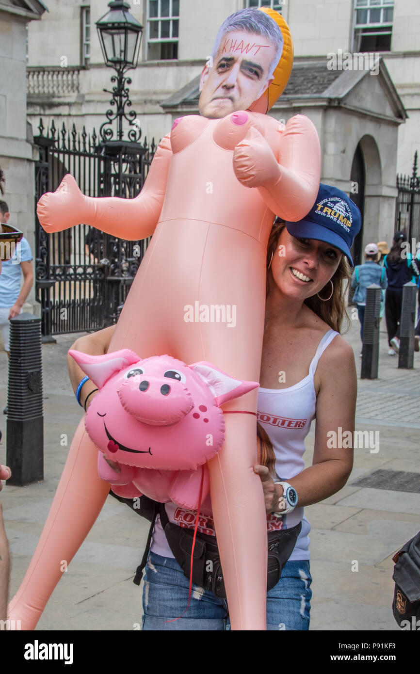 London, UK, 14, July 2018.  Islamophobic racism on Whitehall. A woman holds an inflatable doll with an image of Sadiq Aman Khan, Mayor of London riding a pig. Anti-fascists protesters marched against a right-wing rally in support of the jailed Islamophobe Tommy Robinson in central London. David Rowe/Alamy Live News Stock Photo