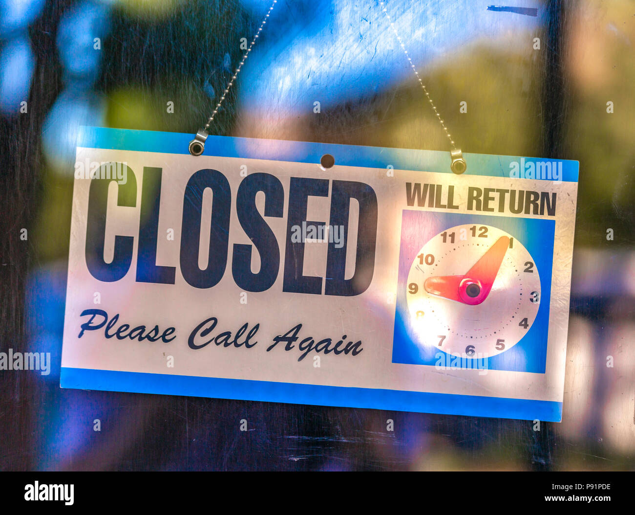 Closed sign with clock display Stock Photo - Alamy