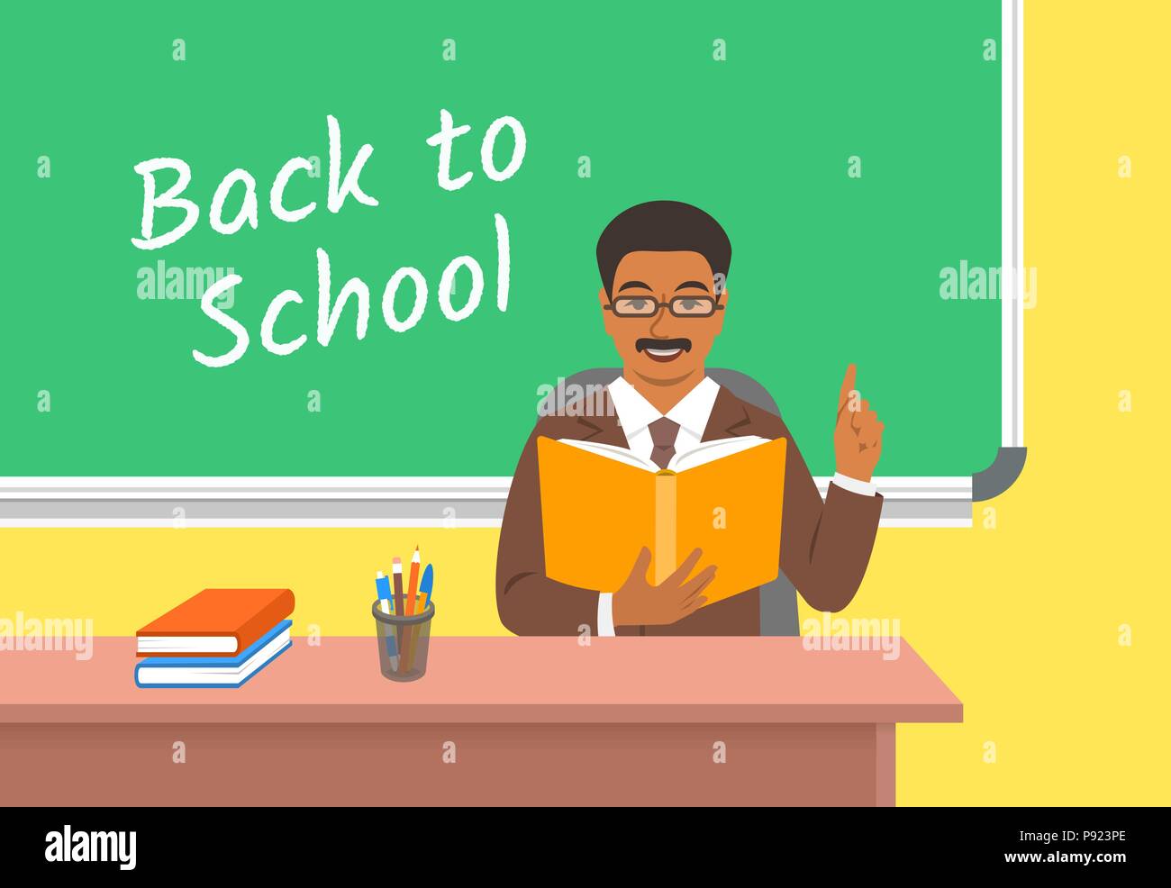 Teacher Black Man With Open Book Sitting At The Desk In Classroom
