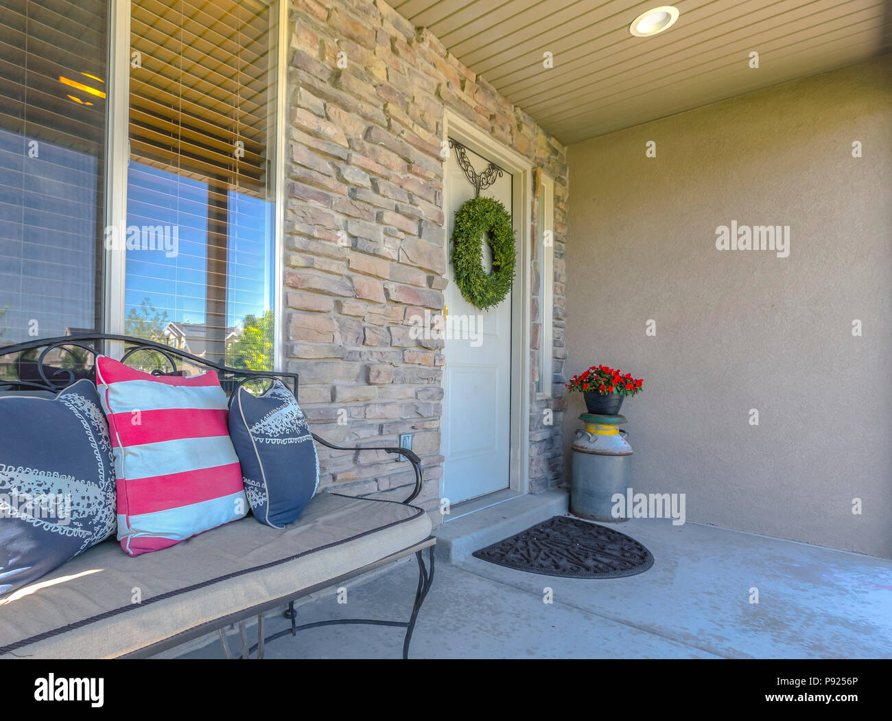 Stone wall entry with bench near front door Stock Photo Alamy