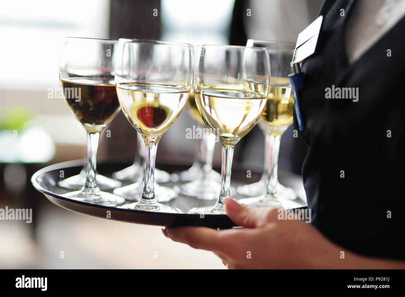 Waitress Holding A Dish Of Champagne And Wine Glasses At Festive