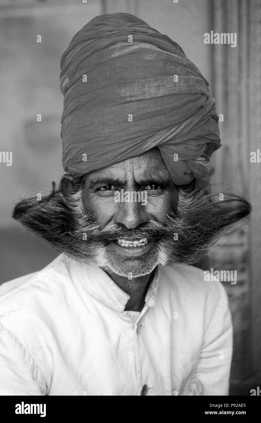 GUARD with RED TURBAN and 'soup-strainer' MUSTACHE and BEARD at the CITY PALACE in JAIPUR - RAJASTHAN, INDIA Stock Photo