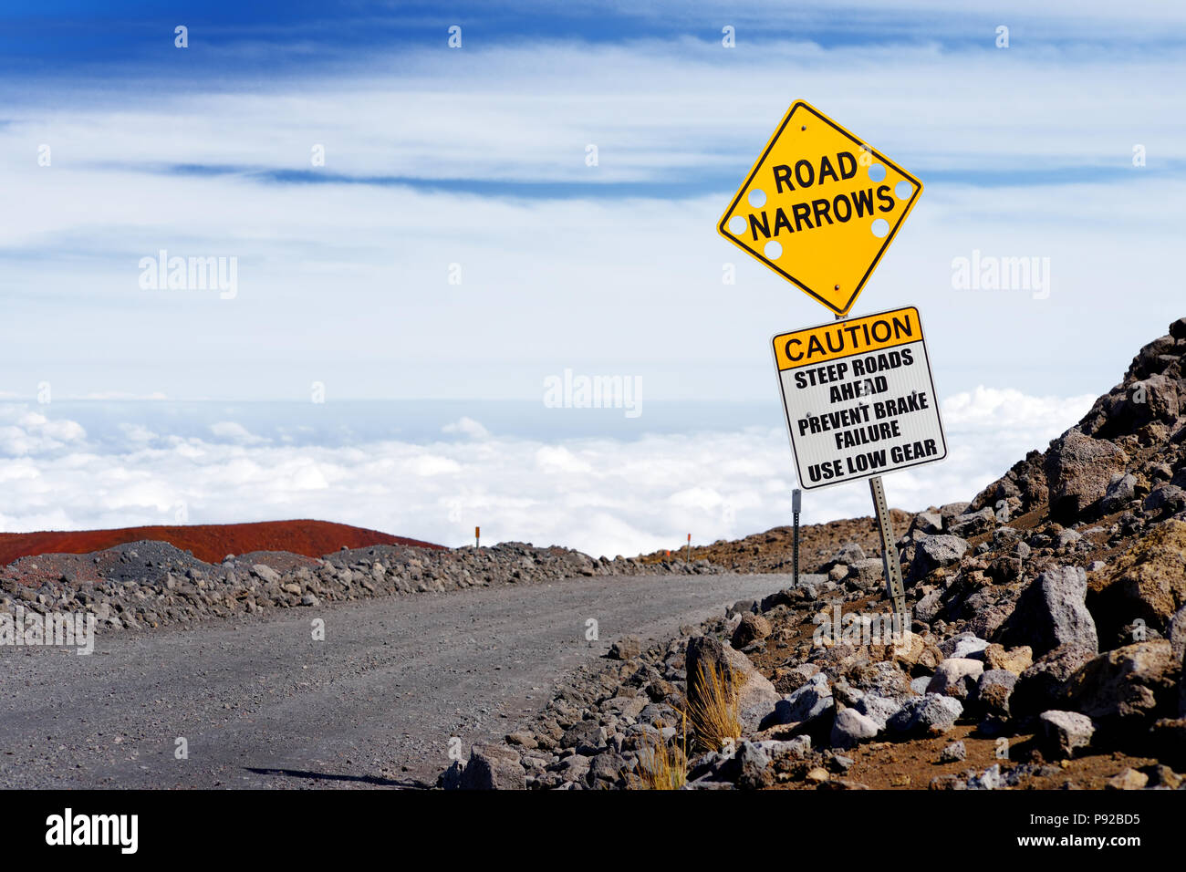 A road sign on a steep road to the summit of Mauna Kea, a dormant
