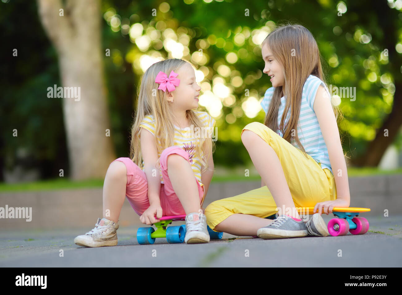 Little girl figure skater skating on ice indoor Stock Photo. 