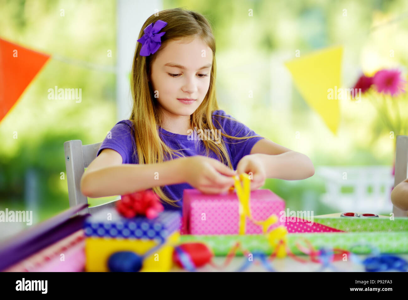 https://c8.alamy.com/comp/P92FA3/cute-preteen-girl-wrapping-gifts-in-colorful-wrapping-paper-adorable-child-wrapping-birthday-presents-family-fun-P92FA3.jpg