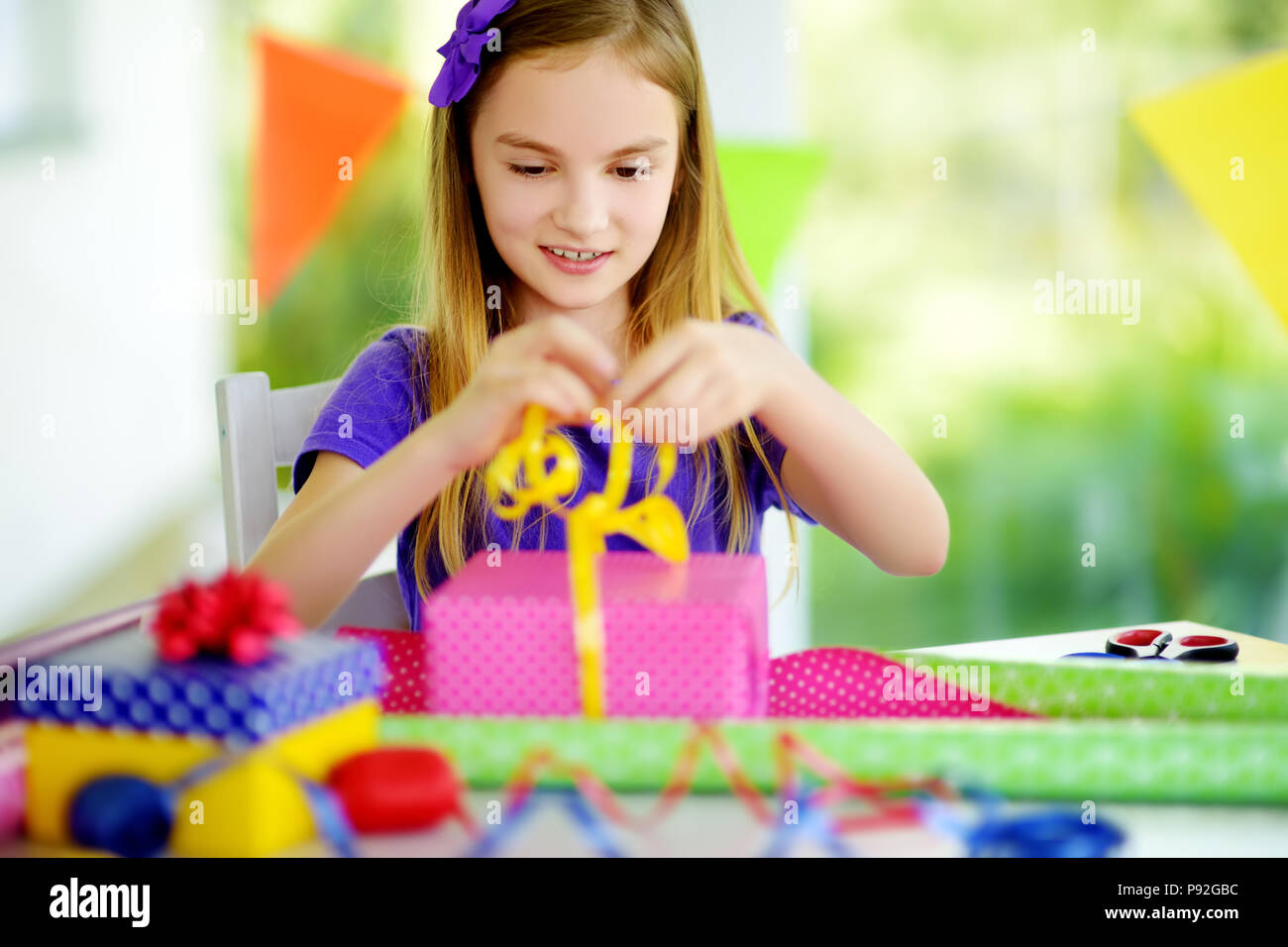 https://c8.alamy.com/comp/P92GBC/cute-preteen-girl-wrapping-gifts-in-colorful-wrapping-paper-adorable-child-wrapping-birthday-presents-family-fun-P92GBC.jpg