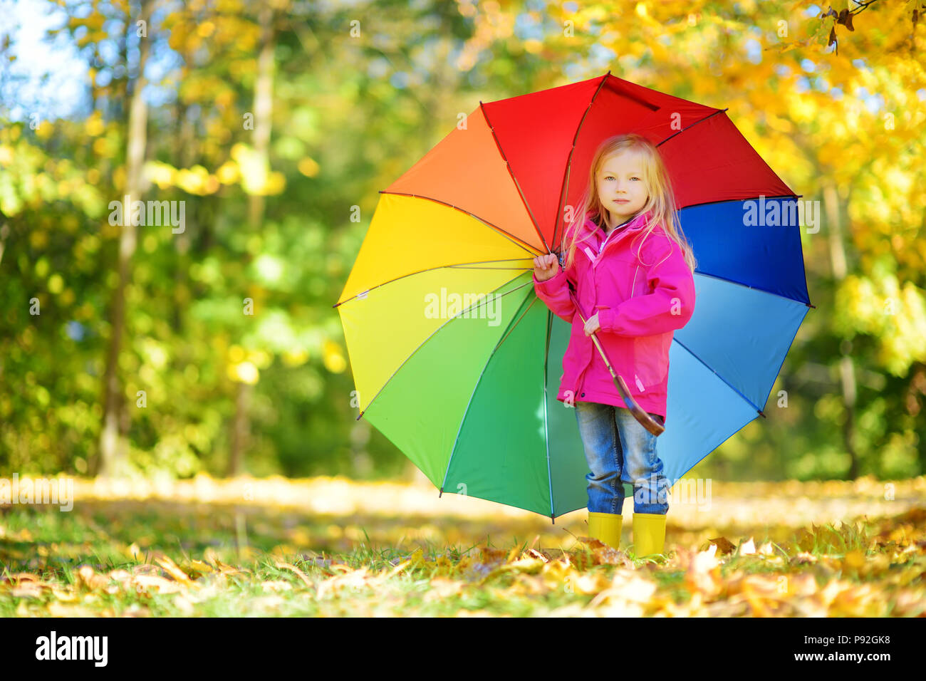 Cute Little Girl Holding Rainbow Umbrella On Beautiful
