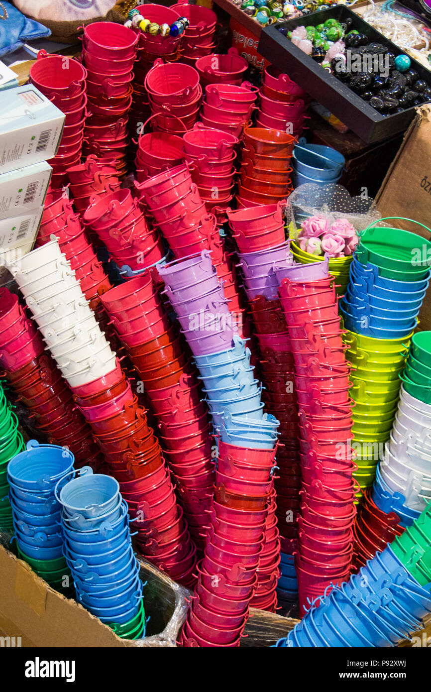 Little set of buckets of various colors in a market place Stock Photo