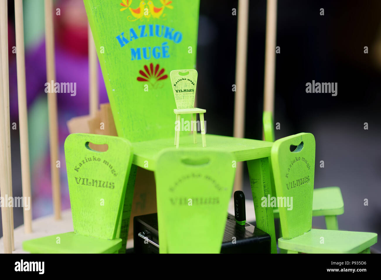 Little green chairs as symbol of traditional spring fair sold on Easter market in Vilnius. Lithuanian capital's annual traditional crafts fair is held Stock Photo