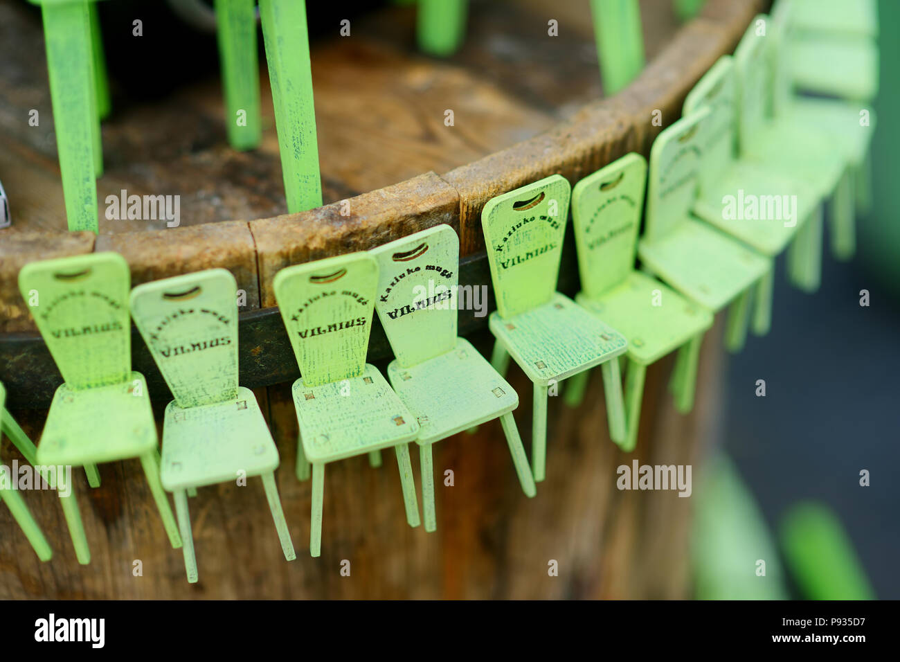 Little green chairs as symbol of traditional spring fair sold on Easter market in Vilnius. Lithuanian capital's annual traditional crafts fair is held Stock Photo