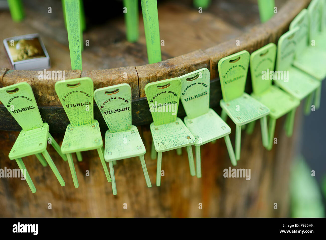 Little green chairs as symbol of traditional spring fair sold on Easter market in Vilnius. Lithuanian capital's annual traditional crafts fair is held Stock Photo