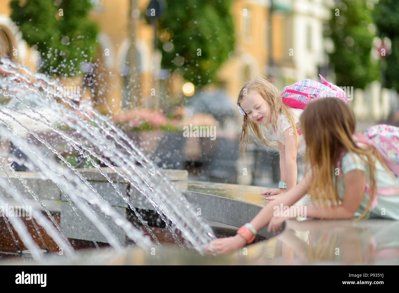 Young Girls Playing Fountain High Resolution Stock Photography and