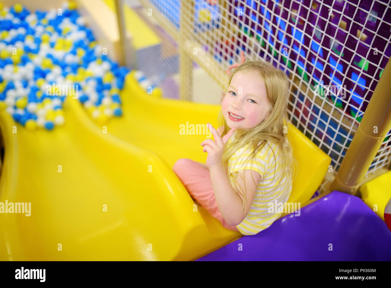 Happy Little Girl Having Fun In Ball Pit In Kids Indoor Play