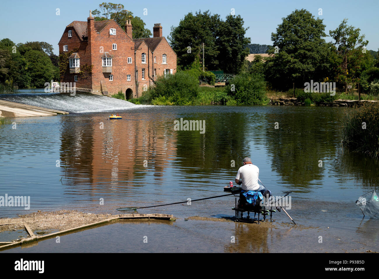 Angler on the River Avon opposite Cropthorne Mill, Worcestershire, England, UK Stock Photo