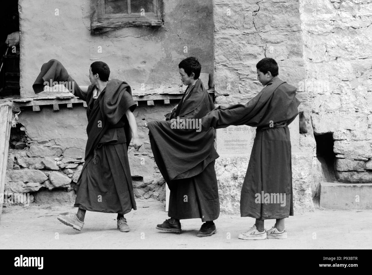 MONKS of the KAGYU SECT of TIBETAN BUDDHISM practice their ceremonial dances at DRIGUNG MONASTERY  - TIBET Stock Photo