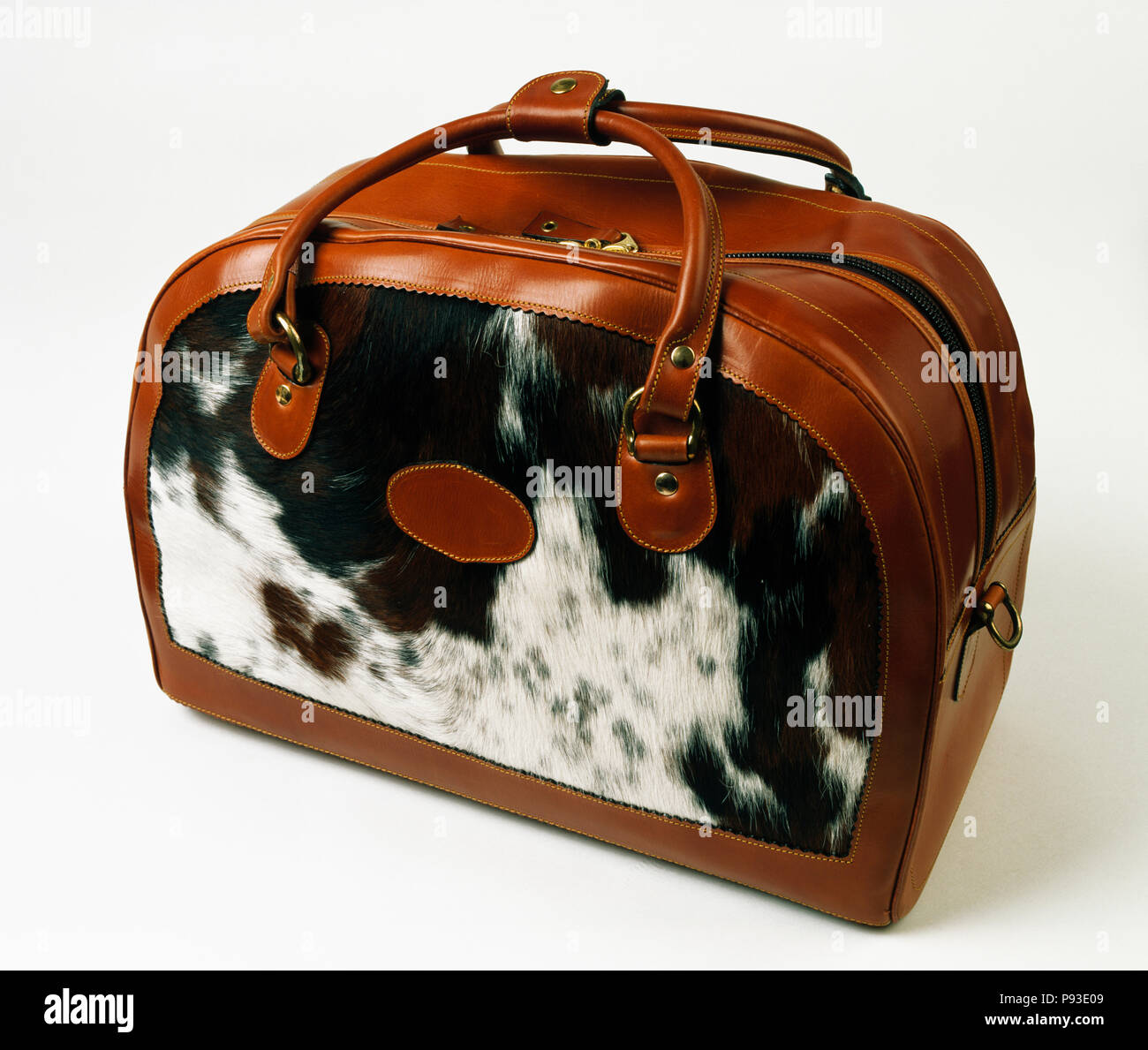 Close-up of faux animal-skin and brown leather holdall bag Stock Photo -  Alamy