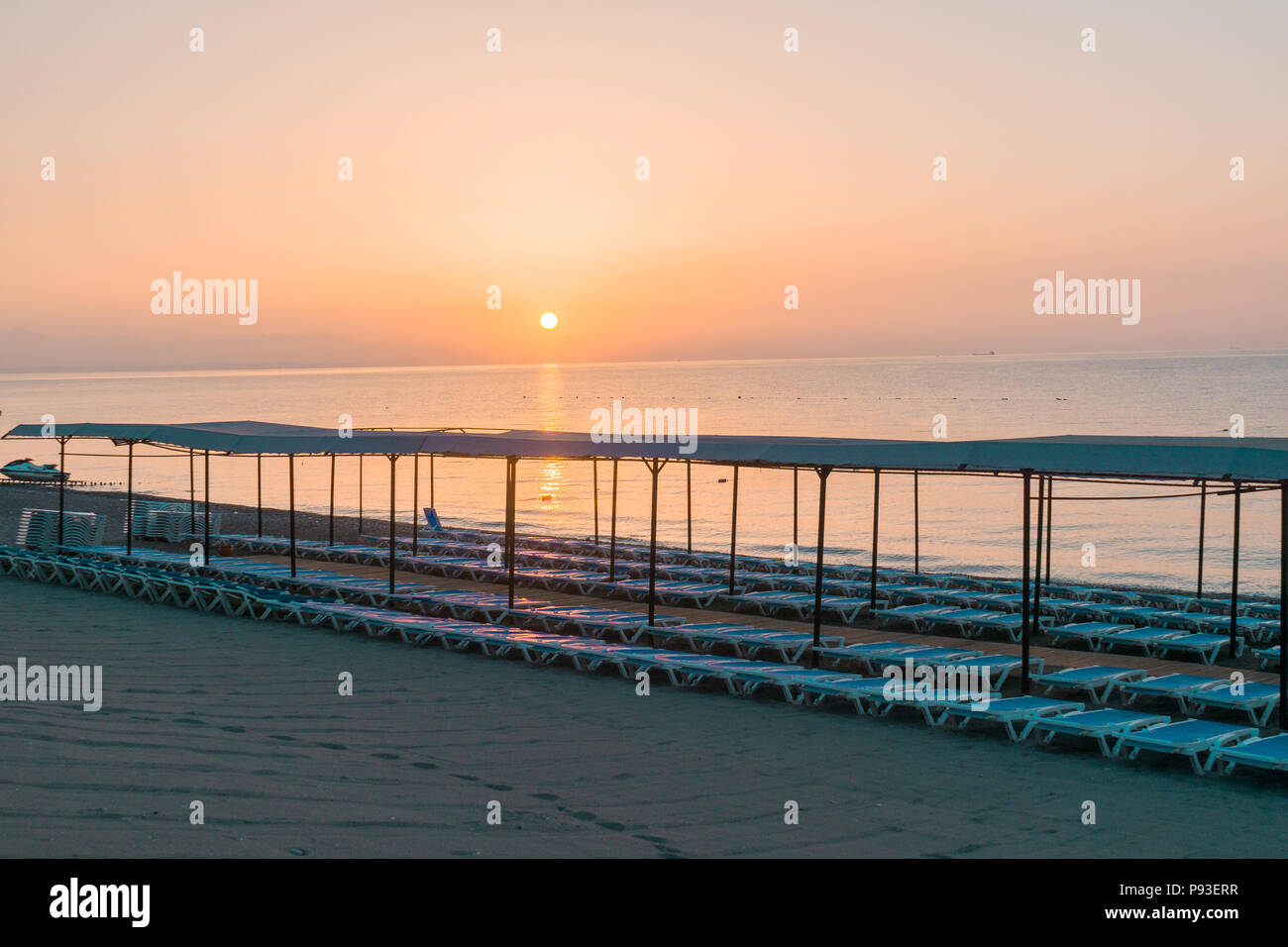 Beach in morning with sun loungers Stock Photo