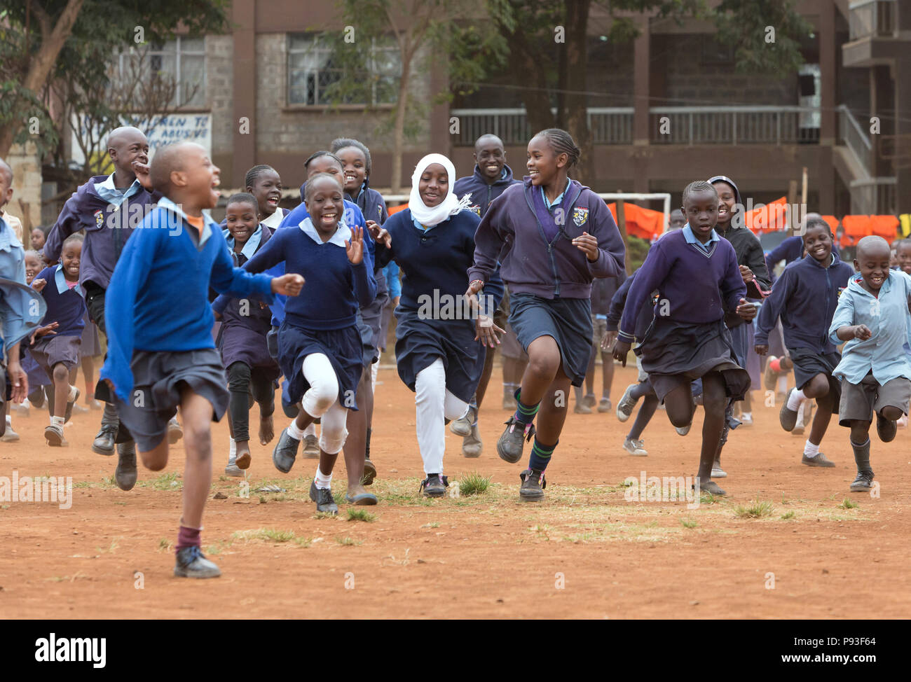 Nairobi, Kenya - Students in school uniforms compete in the schoolyard of St. John's Community Center Pumwani. Stock Photo