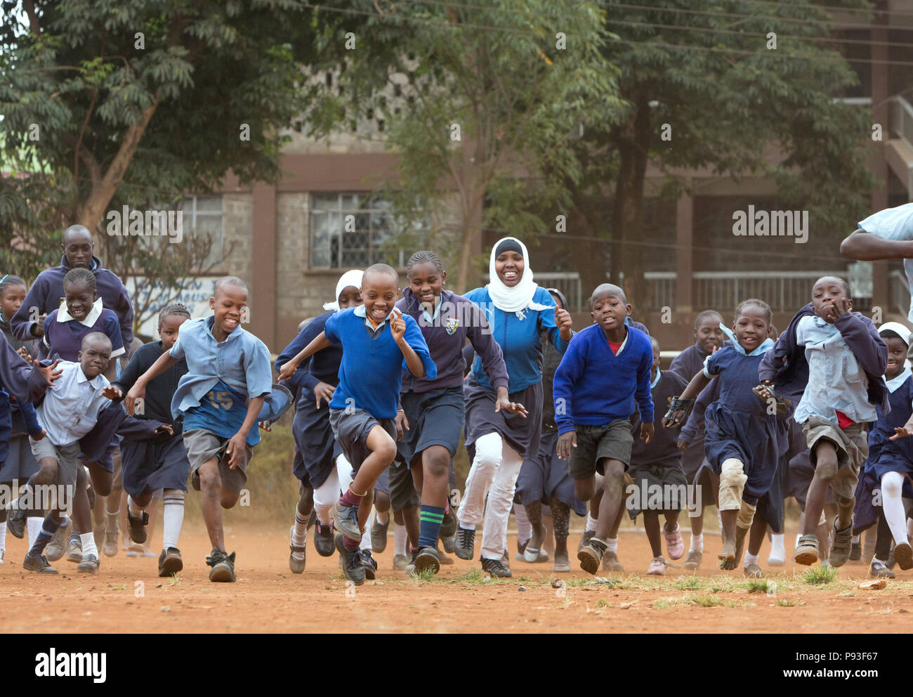 Nairobi, Kenya - Students in school uniforms compete in the schoolyard of St. John's Community Center Pumwani. Stock Photo