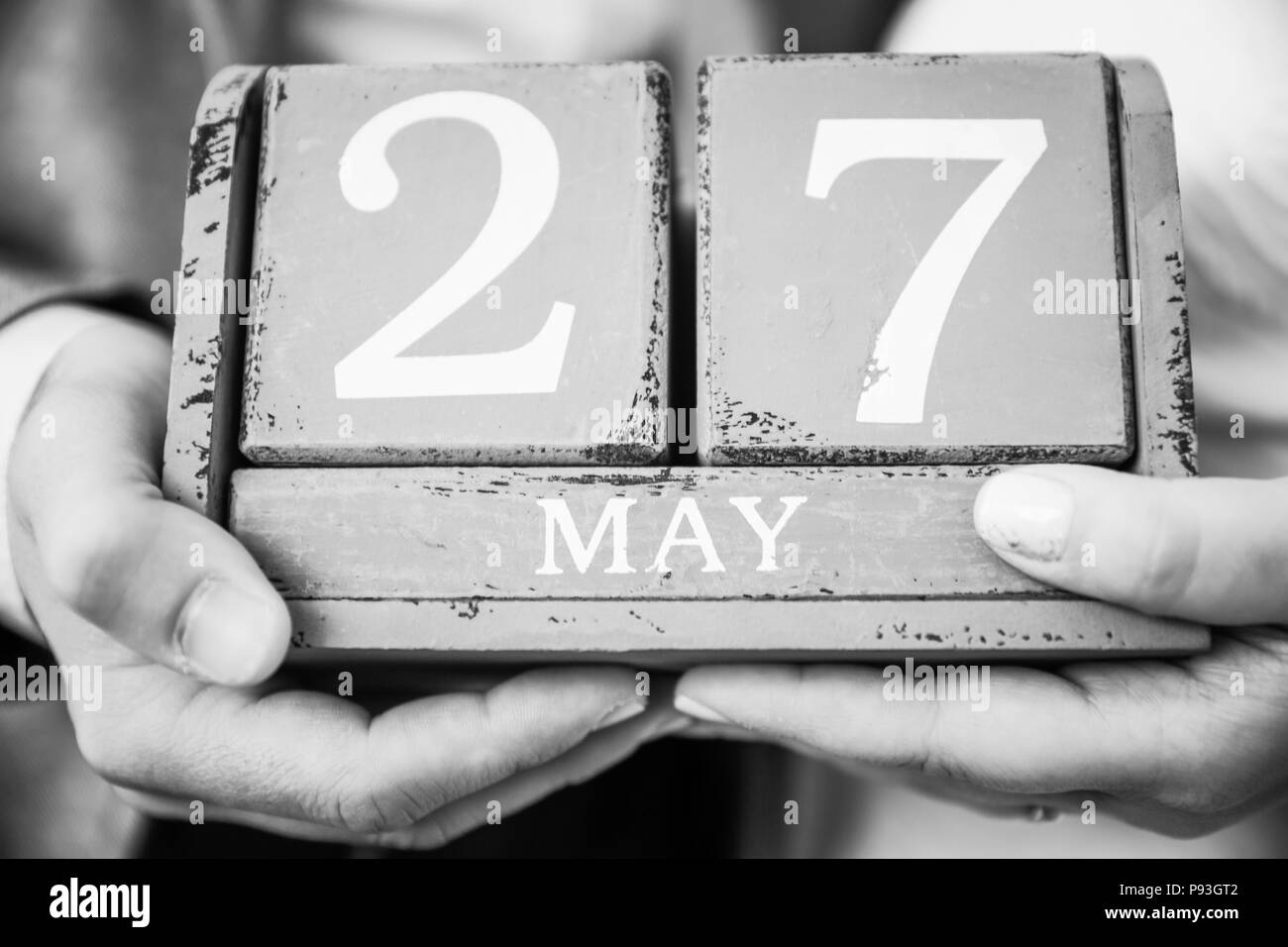 Newly Wed Couple Holding May 27 Date in their Hands Stock Photo