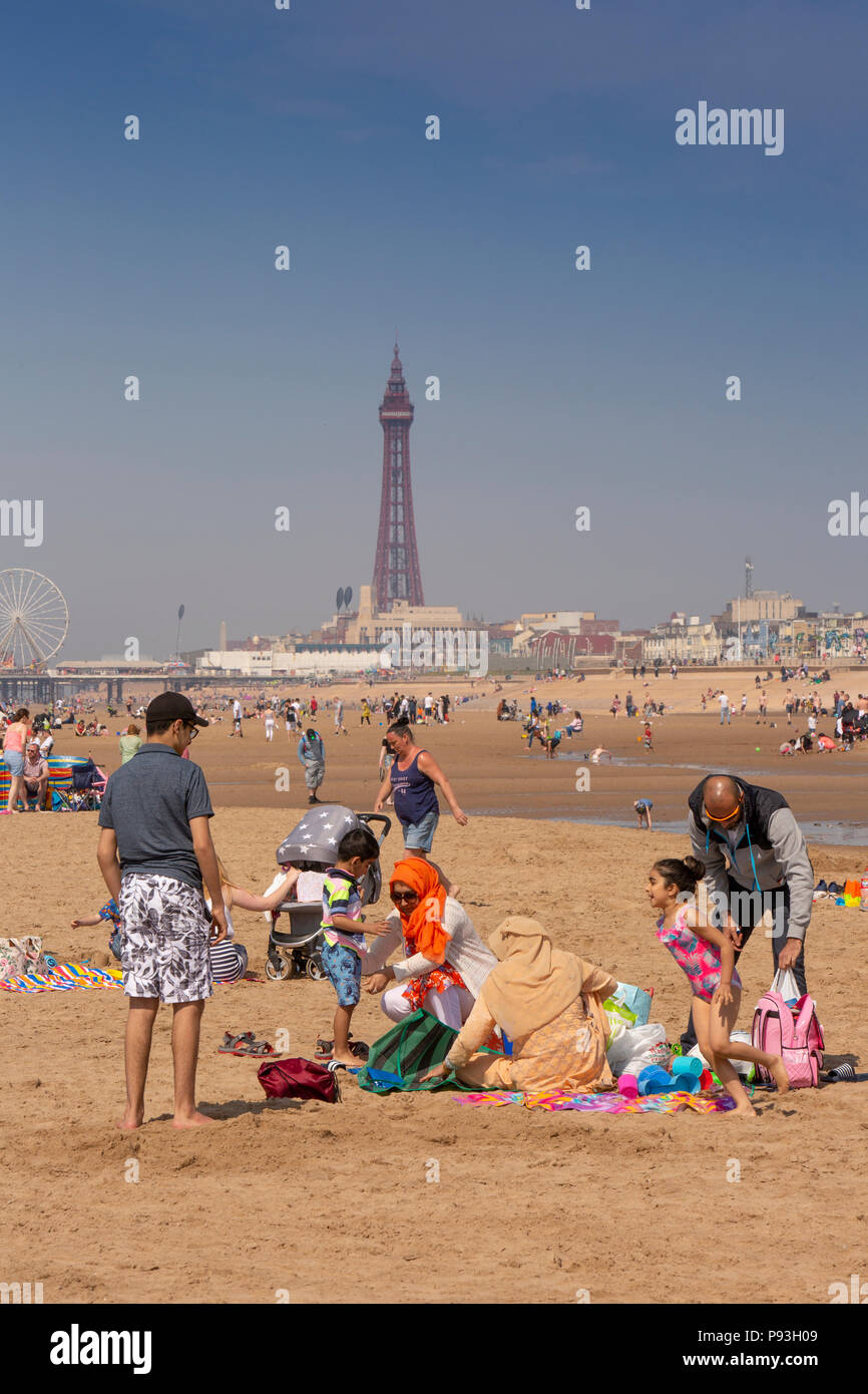 UK, England, Lancashire, Blackpool, modestly dressed Moslem family from Blackburn on beach Stock Photo