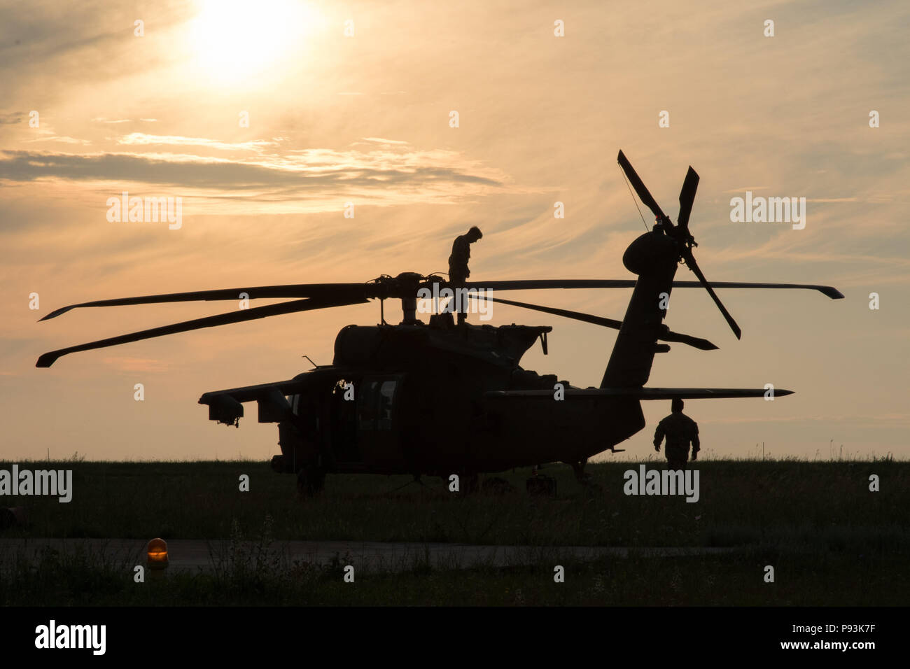U.S. Soldiers assigned to the 2nd General Support Aviation Battalion, 4th Aviation Regiment, 4th Combat Aviation Brigade, 4th Infantry Division, conduct safety checks and prepare their UH-60 Blackhawk for air assault training at Mihail Koglniceanu Air Base, Romania, July 10, 2018. The Soldiers of 2nd GSAB are conducting similar training in multiple locations throughout Europe in support of Atlantic Resolve, a U.S. endeavor to fulfill NATO commitments by rotating U.S.-based units throughout the European theater to deter aggression against NATO allies and partners in Europe. (U.S. Army photo by  Stock Photo